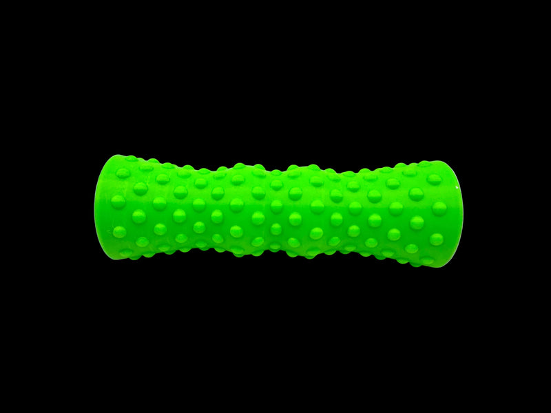 A bright green textured roller with a raised dotted pattern, photographed horizontally on a plain white surface.